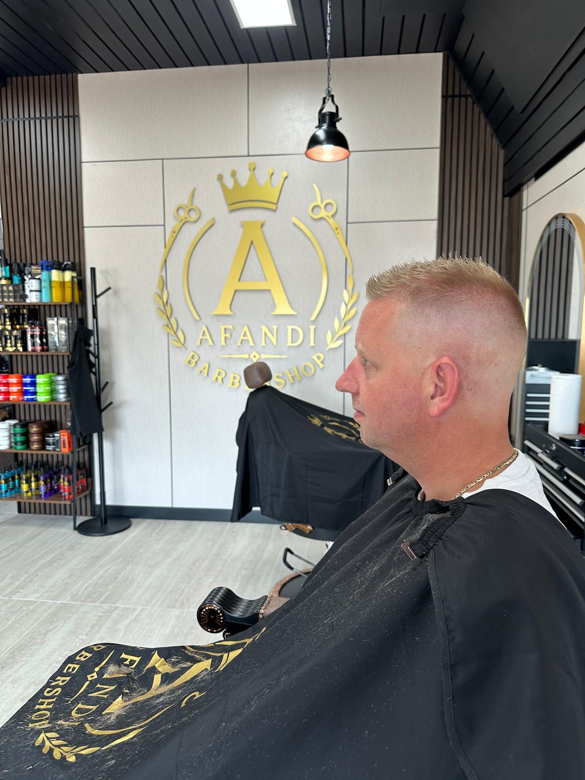 Klant met een kort, strak geknipt kapsel onder de Afandi-kapmantel